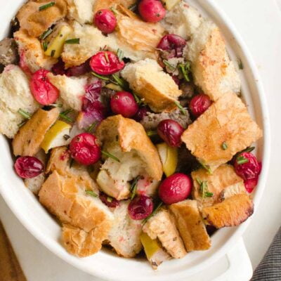 cranberry sausage stuffing in oval white casserole dish